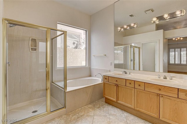 full bath with visible vents, a sink, a shower stall, tile patterned flooring, and a bath