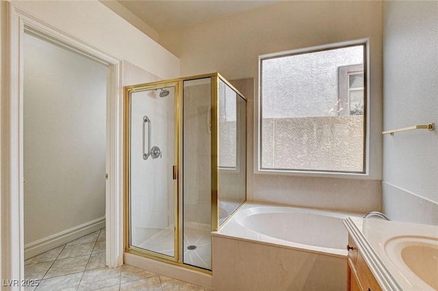 full bathroom featuring vanity, tile patterned floors, a garden tub, and a shower stall