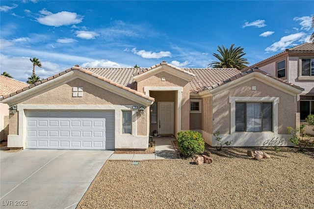 view of front of home featuring stucco siding, an attached garage, driveway, and a tile roof