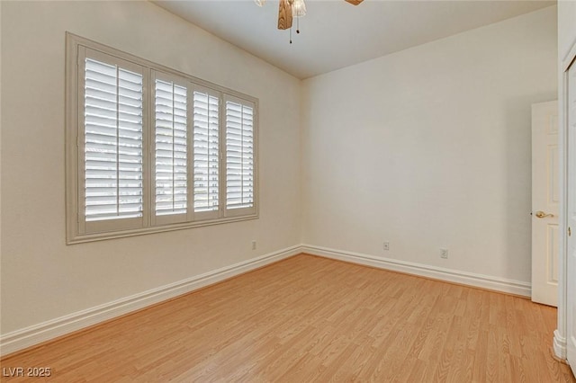 spare room with light wood-style flooring, baseboards, and ceiling fan