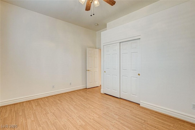 unfurnished bedroom with light wood-style floors, baseboards, a closet, and ceiling fan