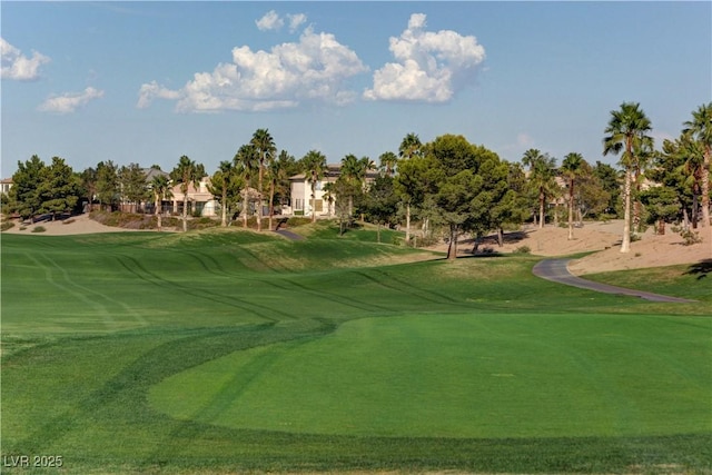 view of home's community with a lawn and view of golf course