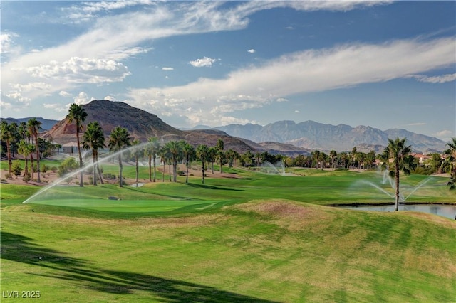 view of community with a water and mountain view and view of golf course