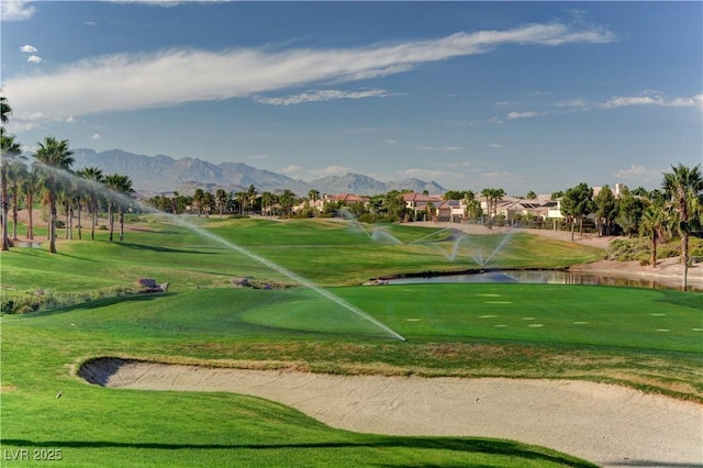 surrounding community featuring view of golf course and a water and mountain view