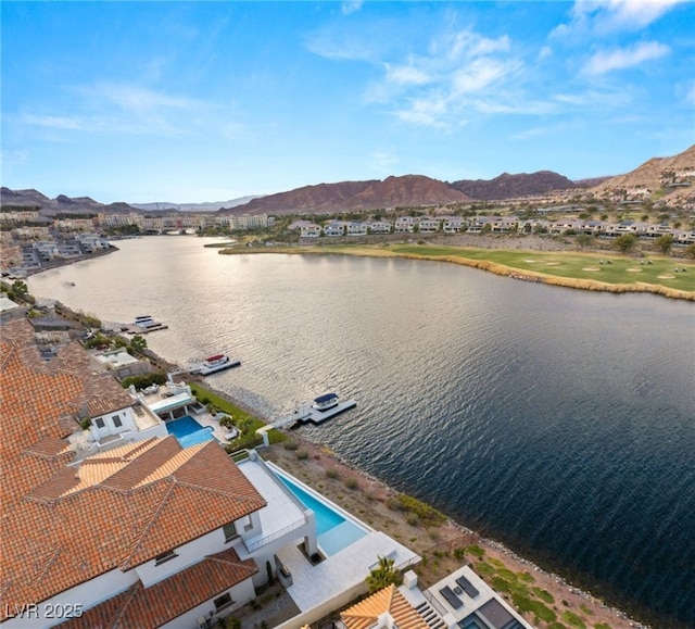 birds eye view of property featuring a water and mountain view