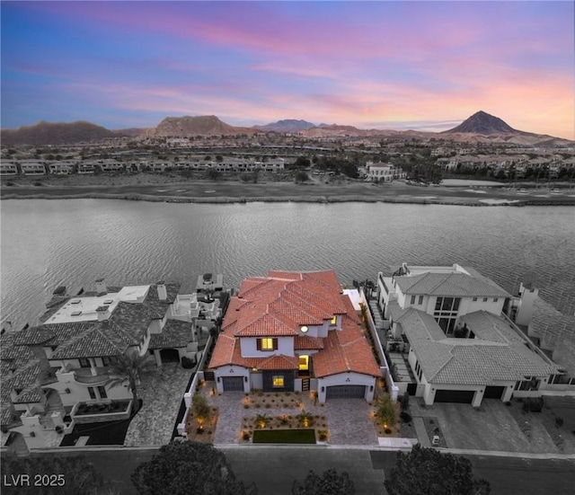 drone / aerial view featuring a water and mountain view