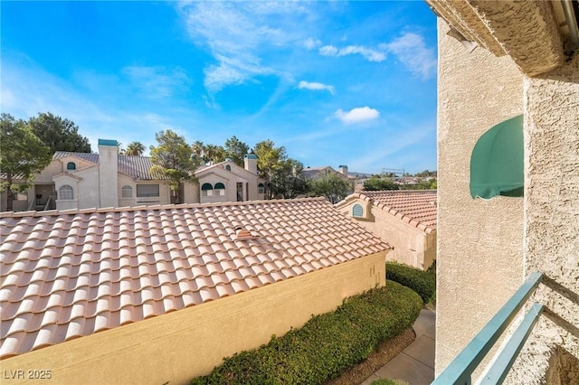 view of property exterior featuring a tile roof