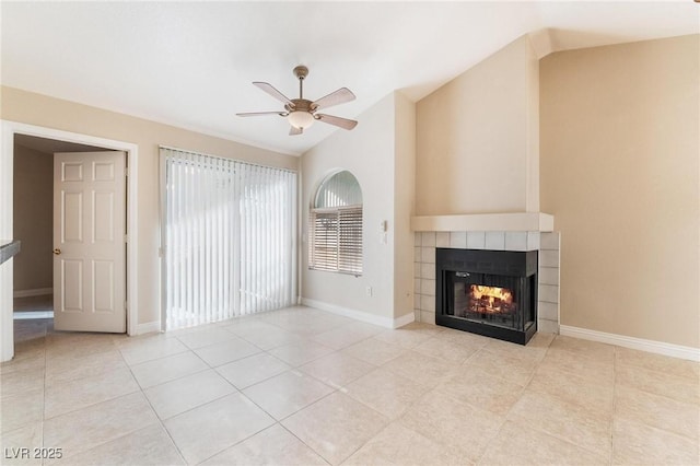 unfurnished living room with light tile patterned floors, baseboards, a ceiling fan, and a fireplace