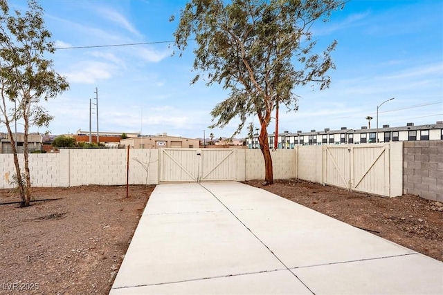 view of yard featuring fence and a gate