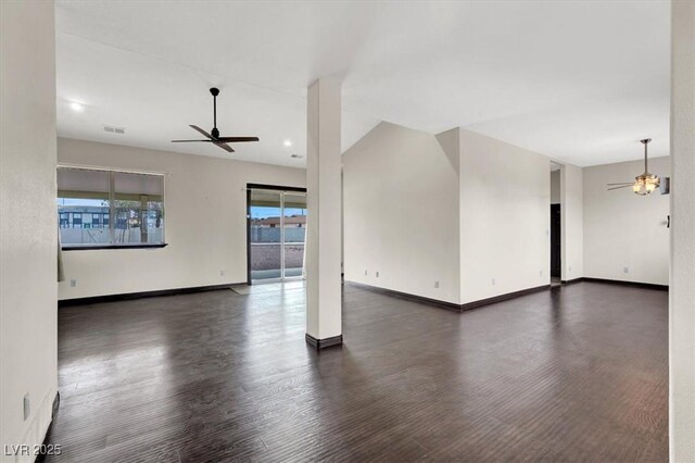 spare room featuring visible vents, baseboards, ceiling fan, and wood finished floors