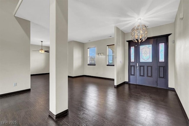 foyer entrance with a chandelier, baseboards, and wood finished floors