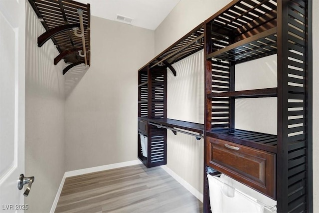 spacious closet with visible vents and wood finished floors