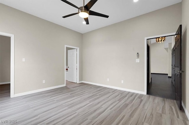 unfurnished room with light wood-style floors, baseboards, and ceiling fan