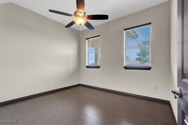 spare room with baseboards, wood finished floors, and a ceiling fan