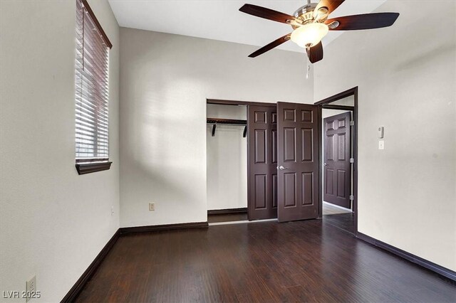 unfurnished bedroom with a closet, a ceiling fan, baseboards, and wood-type flooring