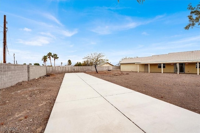 view of yard featuring a patio area and a fenced backyard