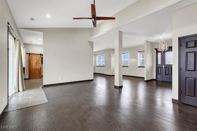 unfurnished living room featuring wood finished floors, visible vents, baseboards, recessed lighting, and a barn door