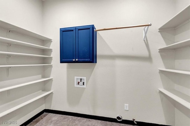 laundry room with cabinet space, hookup for a washing machine, and baseboards