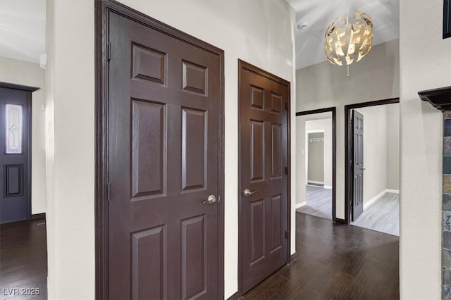 entryway with baseboards and dark wood-style flooring