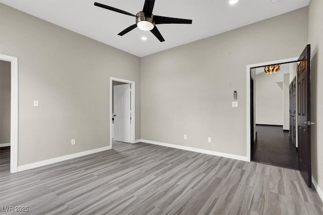 interior space featuring recessed lighting, baseboards, light wood-style flooring, and a ceiling fan