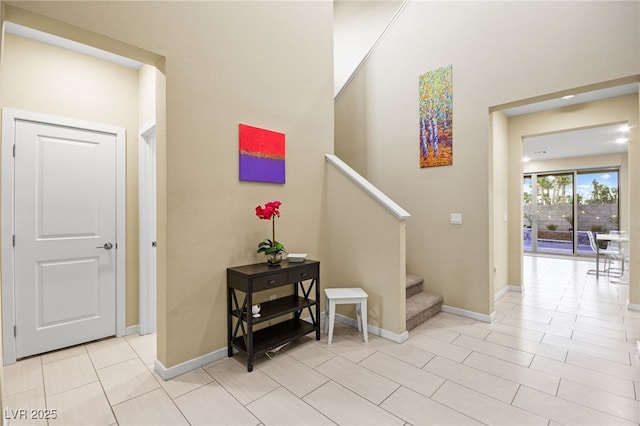 staircase with tile patterned floors and baseboards