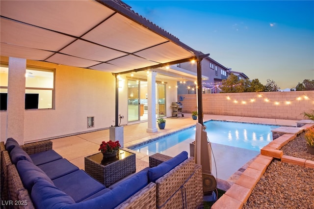 pool at dusk featuring a patio area, a fenced backyard, a fenced in pool, and an outdoor hangout area