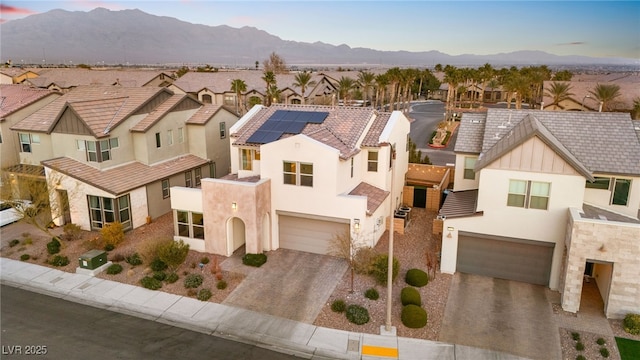 view of front of home featuring decorative driveway, a garage, a residential view, and stucco siding