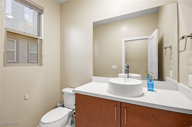 bathroom with toilet and vanity