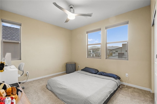 carpeted bedroom featuring baseboards and ceiling fan