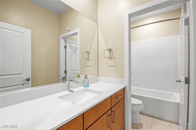 bathroom with vanity, tile patterned floors, toilet, a textured wall, and shower / bathtub combination