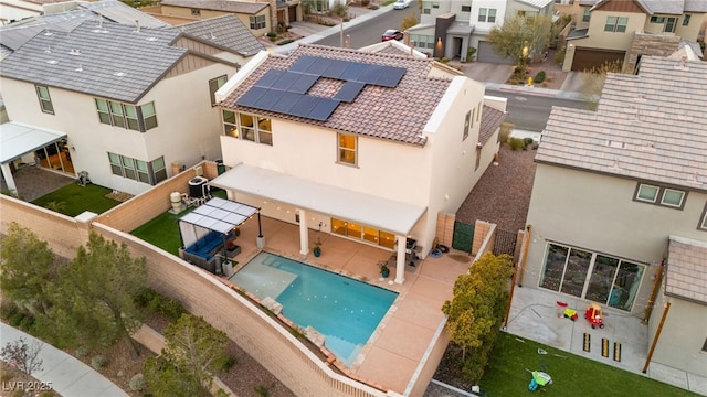 exterior space featuring stucco siding, a residential view, a patio, and a fenced backyard