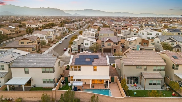 birds eye view of property with a mountain view and a residential view