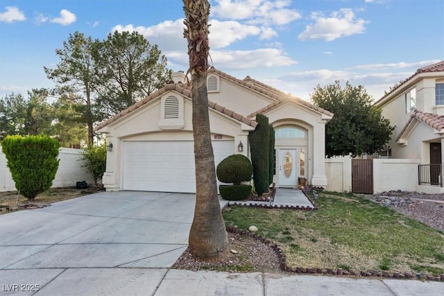 mediterranean / spanish-style house with fence, an attached garage, stucco siding, concrete driveway, and a tile roof