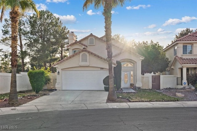 view of front of house featuring stucco siding, fence, concrete driveway, an attached garage, and a tiled roof