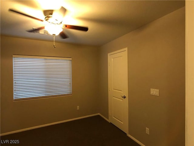 empty room featuring visible vents, baseboards, and a ceiling fan