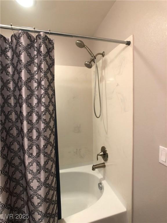 bathroom featuring shower / bathtub combination with curtain