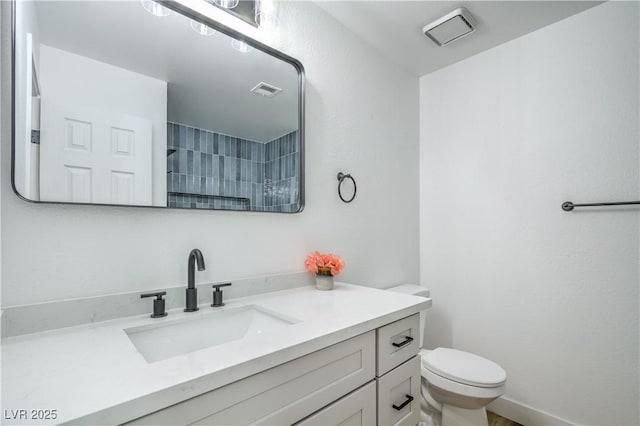 bathroom with visible vents, toilet, vanity, and walk in shower