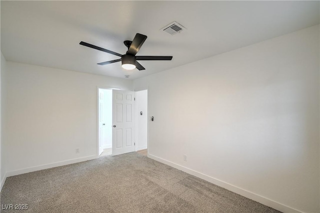 spare room featuring visible vents, baseboards, light colored carpet, and ceiling fan