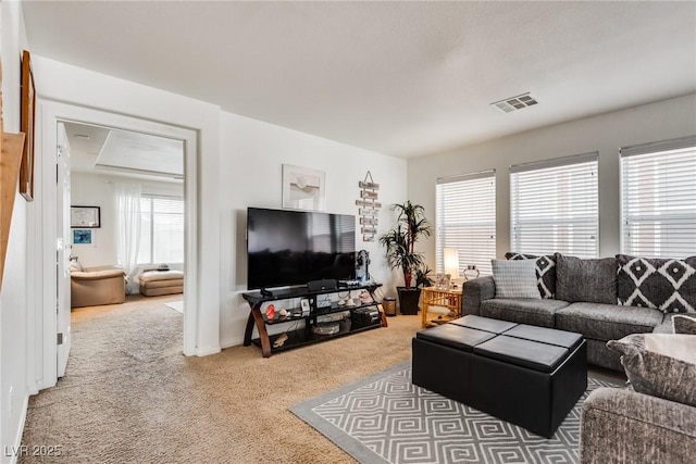 carpeted living area with visible vents