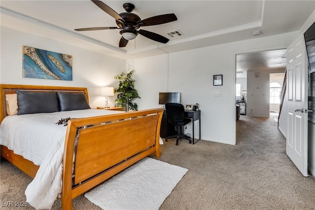 bedroom with visible vents, a raised ceiling, carpet, and a ceiling fan