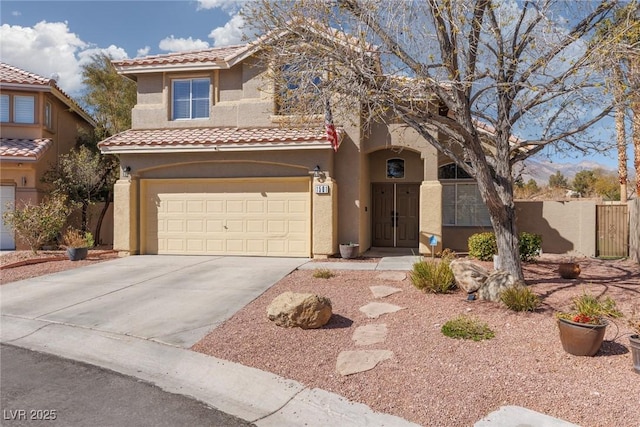 mediterranean / spanish-style house featuring fence, a tiled roof, concrete driveway, stucco siding, and a garage