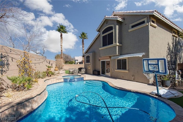 view of pool featuring a patio, a fenced backyard, and a pool with connected hot tub