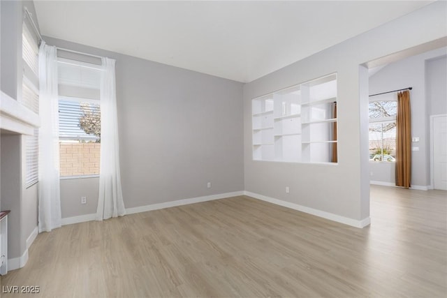 unfurnished room with light wood finished floors and baseboards