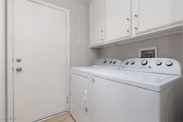 clothes washing area featuring cabinet space and washing machine and clothes dryer