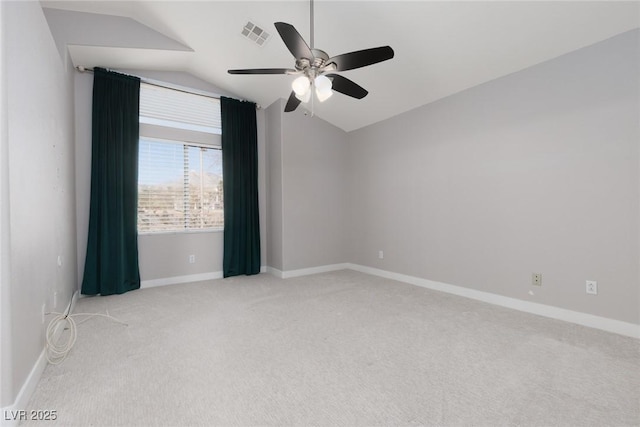 empty room with baseboards, visible vents, ceiling fan, vaulted ceiling, and carpet flooring