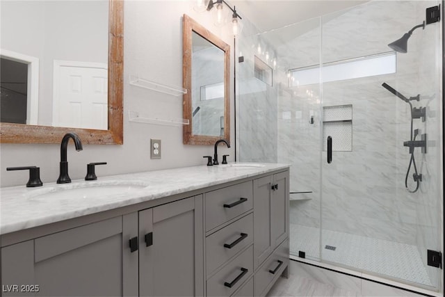 bathroom featuring double vanity, a marble finish shower, marble finish floor, and a sink