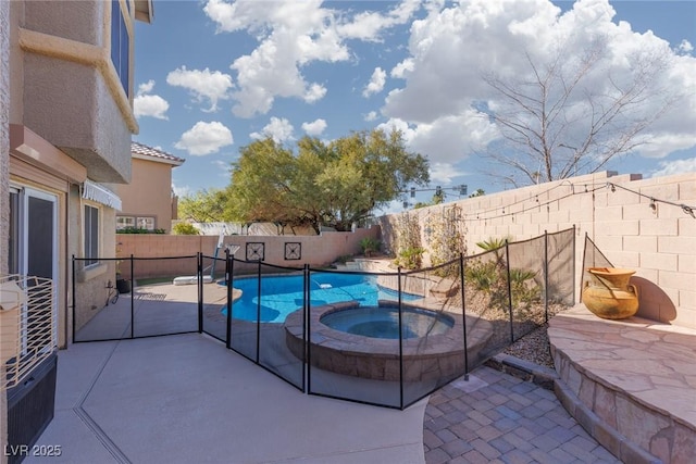 view of swimming pool with a pool with connected hot tub, a fenced backyard, and a patio area