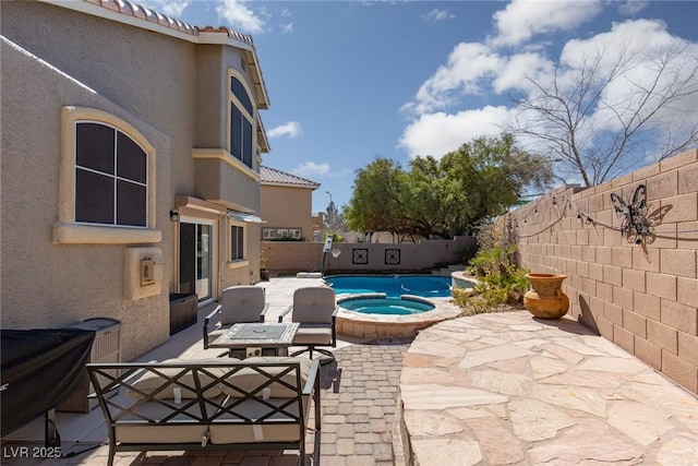 view of pool featuring a patio area, a fenced in pool, an in ground hot tub, and a fenced backyard