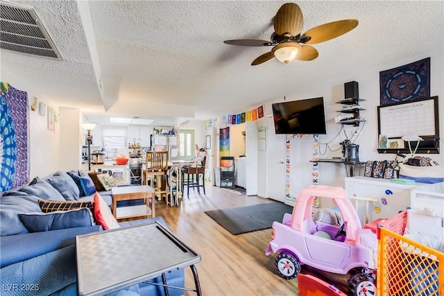5706 W Lake Mead Blvd, Las Vegas, NV 89108 - living room with a textured ceiling, wood finished floors, and a ceiling fan