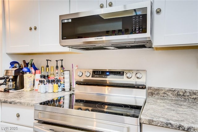 5706 W Lake Mead Blvd, Las Vegas, NV 89108 - kitchen featuring appliances with stainless steel finishes, white cabinetry, and light countertops